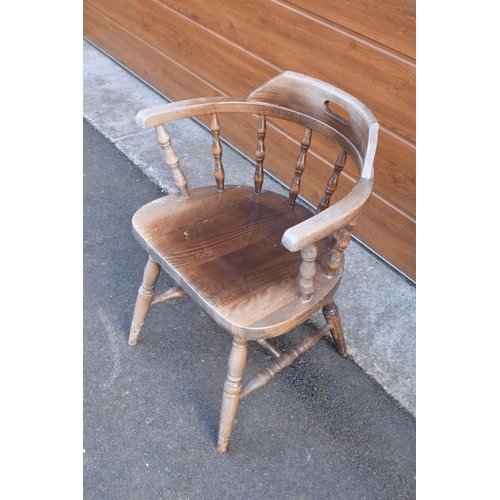 290 - A reproduction wooden captains chair. 76cm tall. In good sturdy condition with some marks, water sta... 