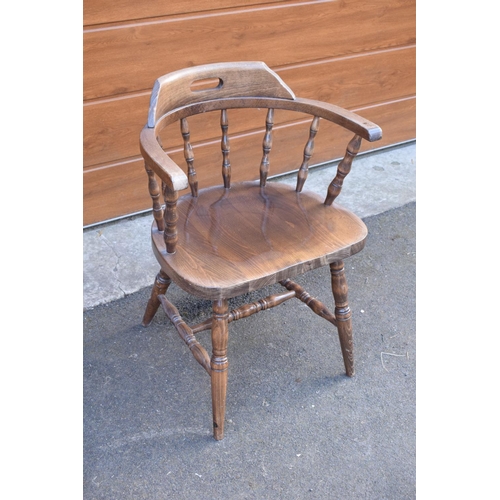 291 - A reproduction wooden captains chair. 76cm tall. In good sturdy condition with some marks, water sta... 