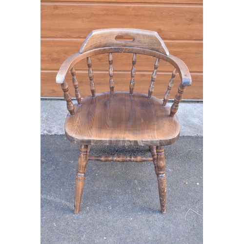 291 - A reproduction wooden captains chair. 76cm tall. In good sturdy condition with some marks, water sta... 