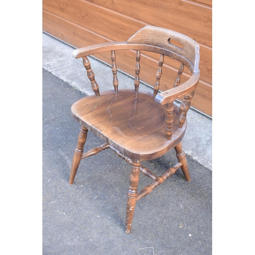 291 - A reproduction wooden captains chair. 76cm tall. In good sturdy condition with some marks, water sta... 