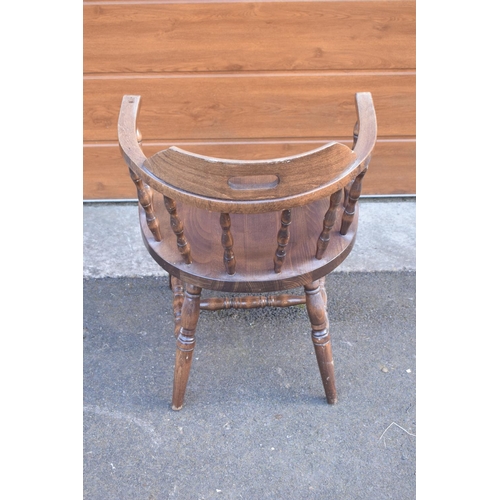 291 - A reproduction wooden captains chair. 76cm tall. In good sturdy condition with some marks, water sta... 