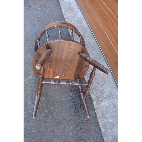 291 - A reproduction wooden captains chair. 76cm tall. In good sturdy condition with some marks, water sta... 