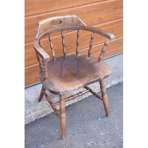 292 - A reproduction wooden captains chair. 76cm tall. In good sturdy condition with some marks, water sta... 