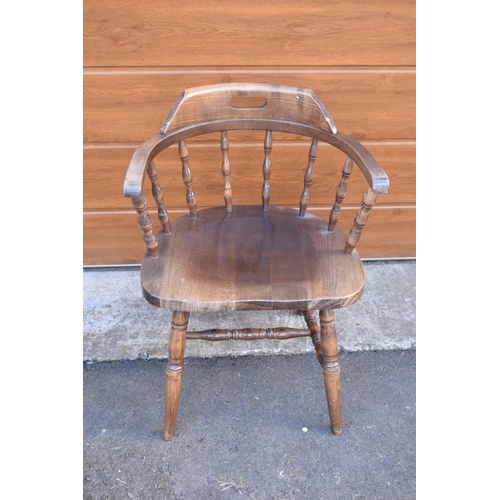 292 - A reproduction wooden captains chair. 76cm tall. In good sturdy condition with some marks, water sta... 