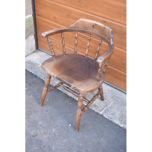 292 - A reproduction wooden captains chair. 76cm tall. In good sturdy condition with some marks, water sta... 