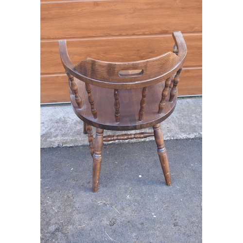 292 - A reproduction wooden captains chair. 76cm tall. In good sturdy condition with some marks, water sta... 