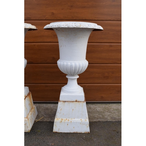296 - A pair of antique heavy cast iron campagna garden urns on matching cast iron bases. Approximately 82... 