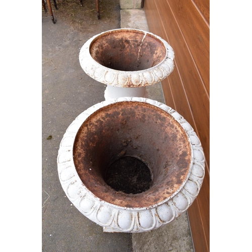 296 - A pair of antique heavy cast iron campagna garden urns on matching cast iron bases. Approximately 82... 
