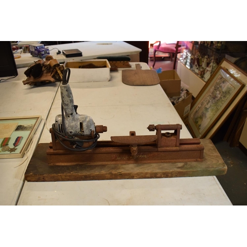 298 - A mid to late 20th century Black and Decker portable lathe mounted on a wooden base. Untested, sold ... 