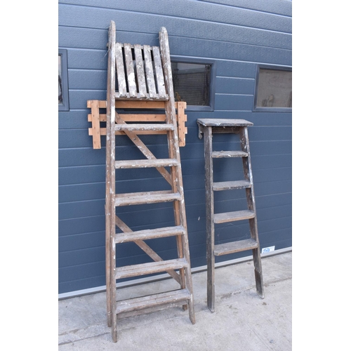 300 - A pair of vintage wooden ladders. Both are rickety and need attention. Signs of old worm. One missin... 