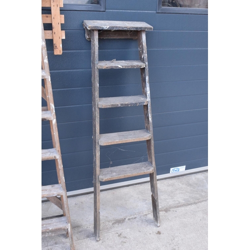 300 - A pair of vintage wooden ladders. Both are rickety and need attention. Signs of old worm. One missin... 