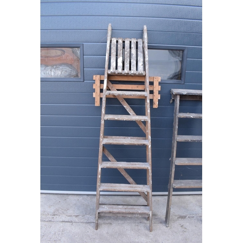 300 - A pair of vintage wooden ladders. Both are rickety and need attention. Signs of old worm. One missin... 