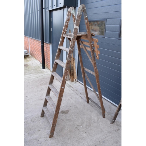 300 - A pair of vintage wooden ladders. Both are rickety and need attention. Signs of old worm. One missin... 