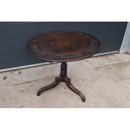 304 - Georgian thick oak oval tilt top table with later Victorian carving depicting fruit scenes. 84 x 72 ... 