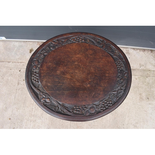 304 - Georgian thick oak oval tilt top table with later Victorian carving depicting fruit scenes. 84 x 72 ... 