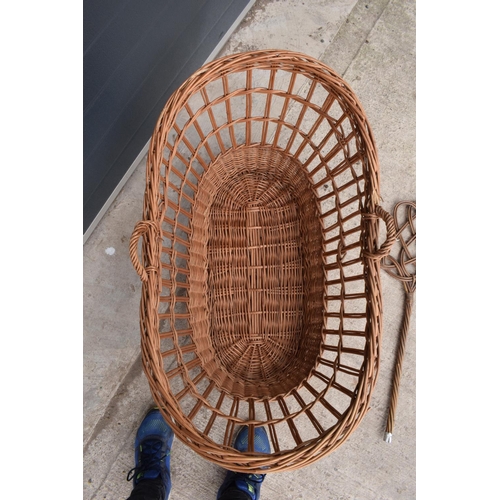 311 - A large wicket basket together with a carpet basher (2).