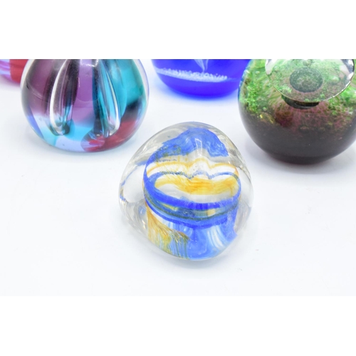 32 - A collection of Caithness glass paperweights to include Pebble, Scimitar, Nebula, Moonlight Dancer, ... 