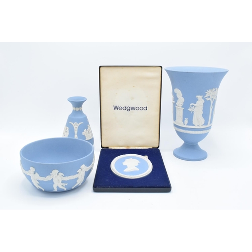 58 - A collection of blue Wedgwood Jasperware to include a large vase, a bowl, a bud vase and a cameo for... 