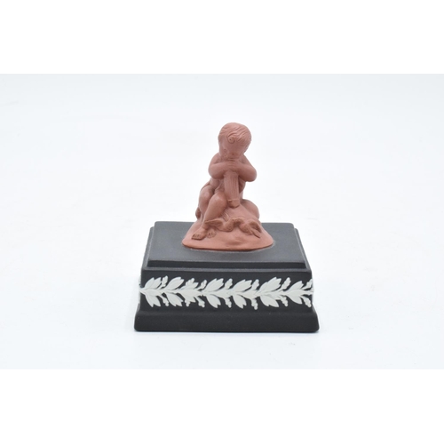 80 - A Wedgwood model of a cherub finial in Terracotta colours mounted on a black jasperware square base ... 