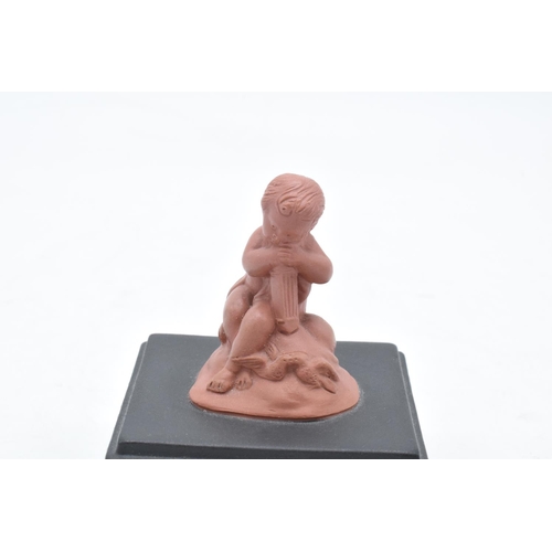 80 - A Wedgwood model of a cherub finial in Terracotta colours mounted on a black jasperware square base ... 