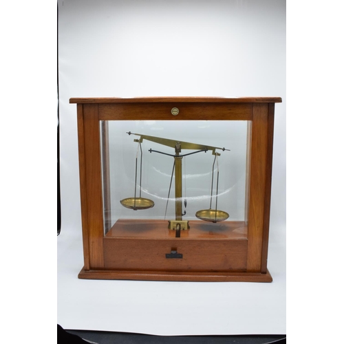 175 - A set of laboratory scales in a wooden case made by Philip Harris and Co Ltd. In good condition. Sol... 