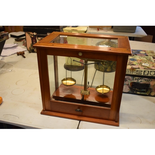 175 - A set of laboratory scales in a wooden case made by Philip Harris and Co Ltd. In good condition. Sol... 