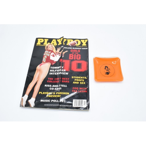 176 - A Playboy glass ashtray together with a magazine from October 1997. Small chip to the ashtray.