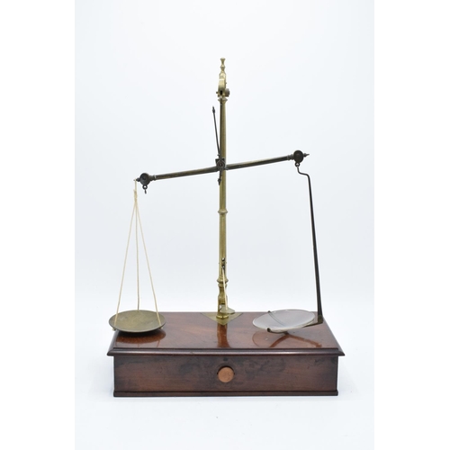 184 - Early 20th century brass scales mounted a wooden base with a pull out. They display well. Might requ... 