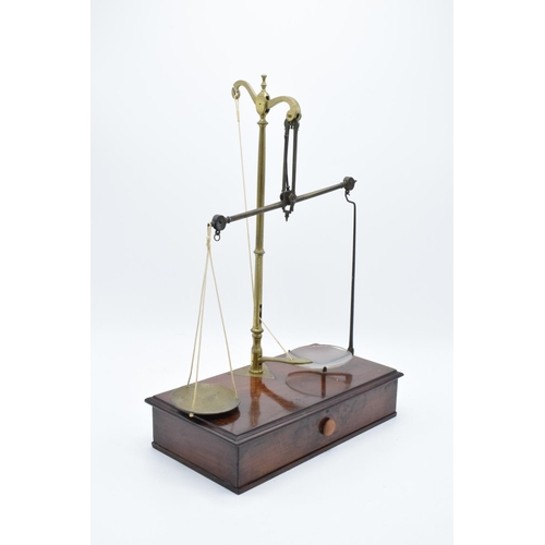 184 - Early 20th century brass scales mounted a wooden base with a pull out. They display well. Might requ... 