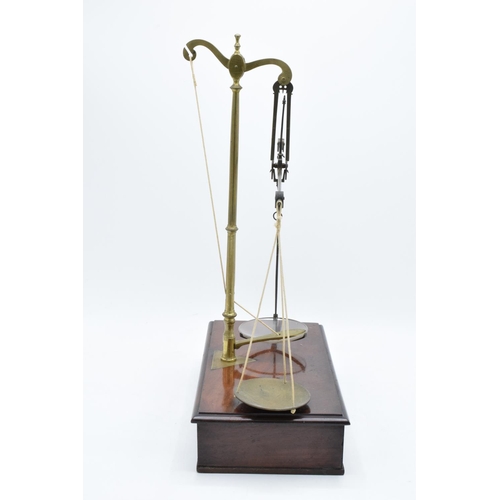 184 - Early 20th century brass scales mounted a wooden base with a pull out. They display well. Might requ... 