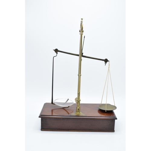 184 - Early 20th century brass scales mounted a wooden base with a pull out. They display well. Might requ... 