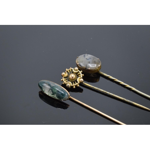 250H - A trio of vintage stick pins to include 2 moss agate examples. With an associated box.