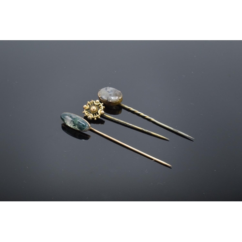 250H - A trio of vintage stick pins to include 2 moss agate examples. With an associated box.