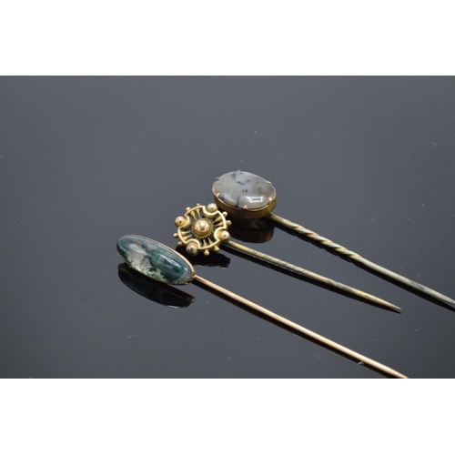 250H - A trio of vintage stick pins to include 2 moss agate examples. With an associated box.