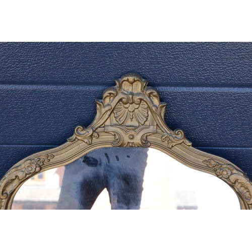 322 - An early 20th century gilt-effect ornate framed mirror. 83cm tall. A crack to the top ornate section... 