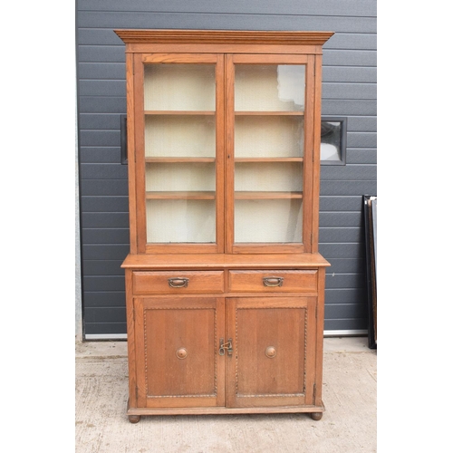 331 - Edwardian/ 20th century golden oak book case with glass doors. In good condition with age related we... 