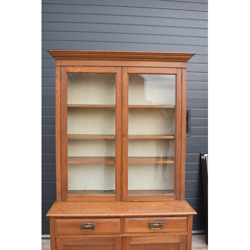 331 - Edwardian/ 20th century golden oak book case with glass doors. In good condition with age related we... 