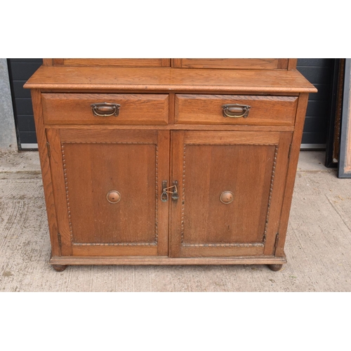 331 - Edwardian/ 20th century golden oak book case with glass doors. In good condition with age related we... 