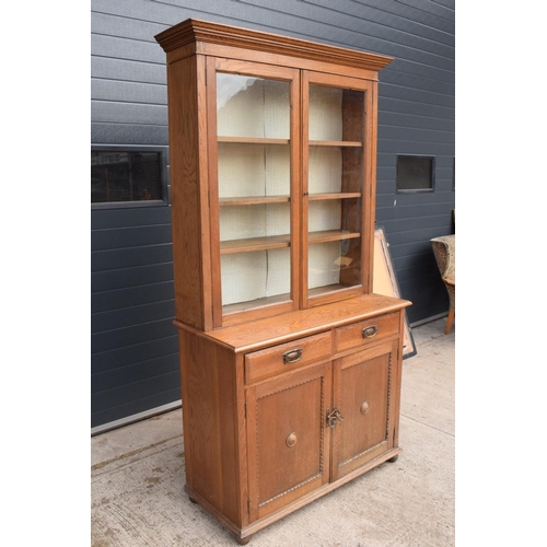 331 - Edwardian/ 20th century golden oak book case with glass doors. In good condition with age related we... 