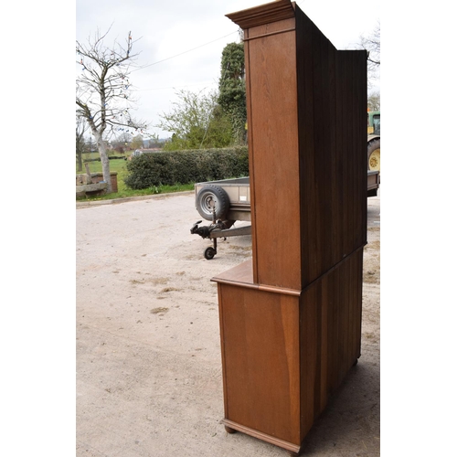 331 - Edwardian/ 20th century golden oak book case with glass doors. In good condition with age related we... 