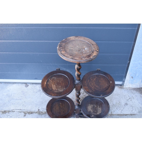 345 - A 1930s wooden lazy waiter/ folding 3 tiered stand. 77cm tall. Age related wear and tear