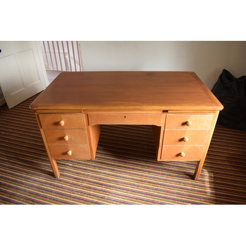 348 - A mid 20th century golden oak desk with draws either side. In good functional condition with age rel... 