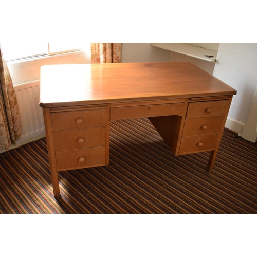 348 - A mid 20th century golden oak desk with draws either side. In good functional condition with age rel... 