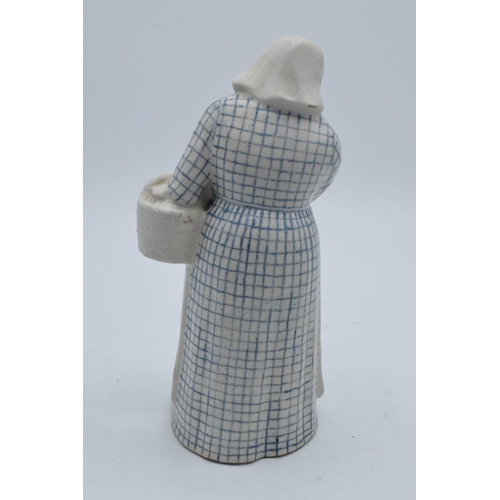 132 - Doulton Lambeth stoneware figure of a Dutch woman with basket, H3. In good condition with no obvious... 