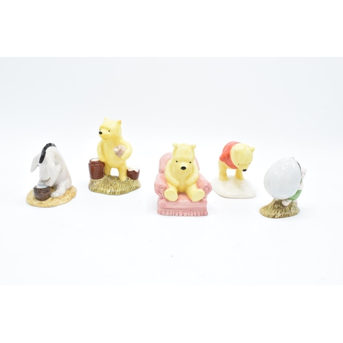 114 - A collection of Royal Doulton Winnie the Pooh figures to include Winnie the Pooh and the paw marks, ... 