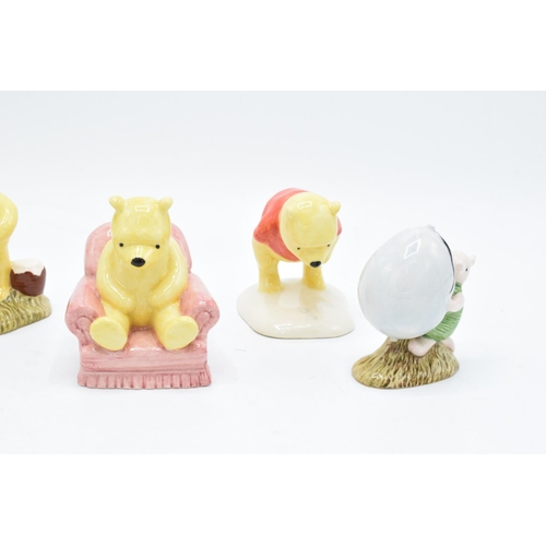 114 - A collection of Royal Doulton Winnie the Pooh figures to include Winnie the Pooh and the paw marks, ... 