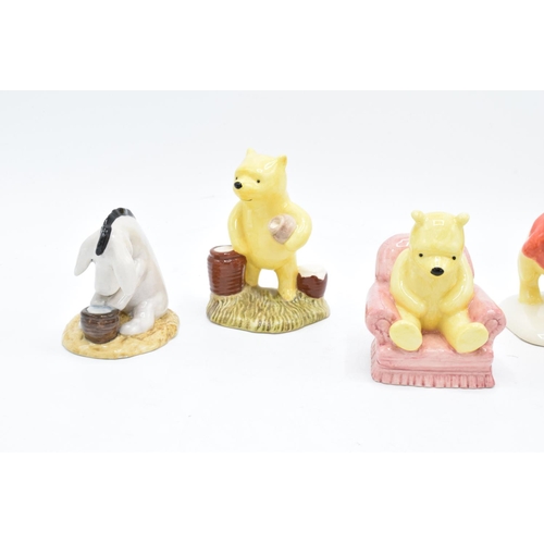 114 - A collection of Royal Doulton Winnie the Pooh figures to include Winnie the Pooh and the paw marks, ... 