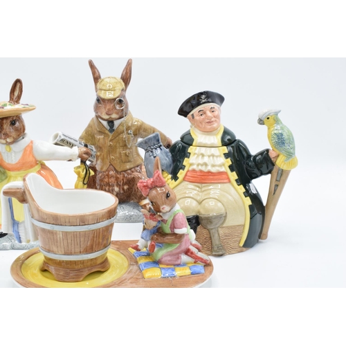 124 - A collection of Royal Doulton to include a Long John Silver character teapot, Bunnykins Lord and Lad... 