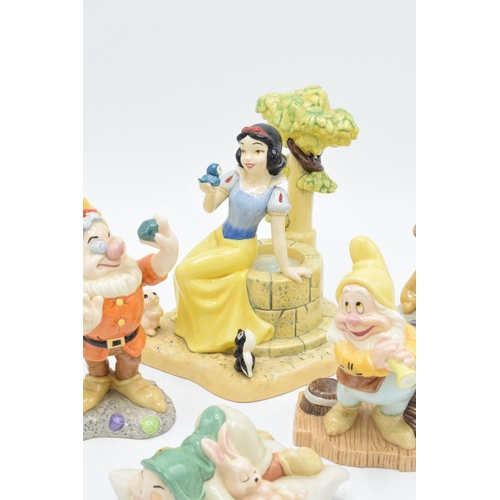 128 - A collection of Royal Doulton Snow White and the 7 Dwarfs figure to include Aw, Shucks SW23, Fairest... 