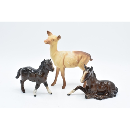 166 - Beswick items to include a brown lying down foal 915, a brown Shetland and a matte doe (3). In good ... 